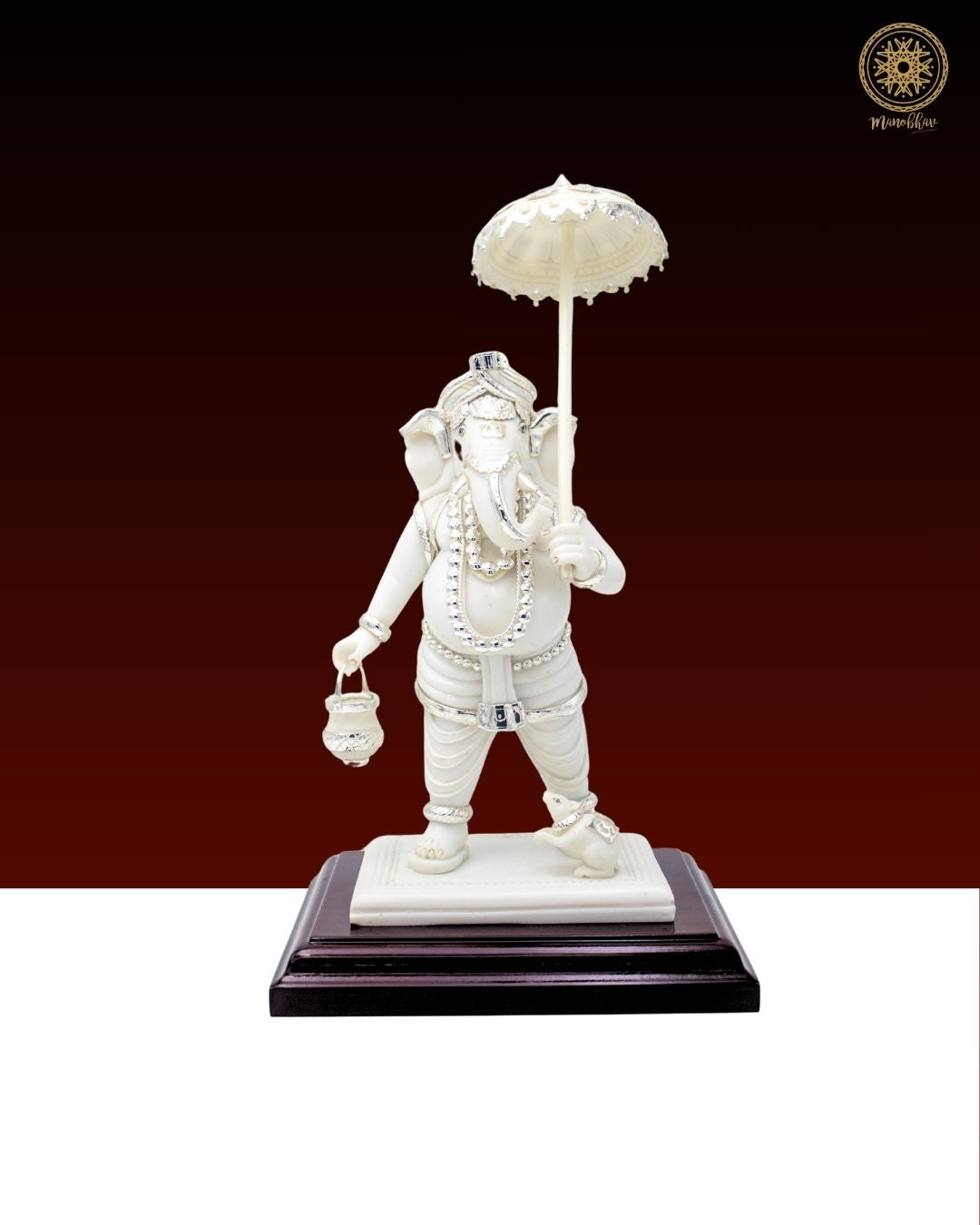 White statue of Ganesh Ji holding an umbrella
