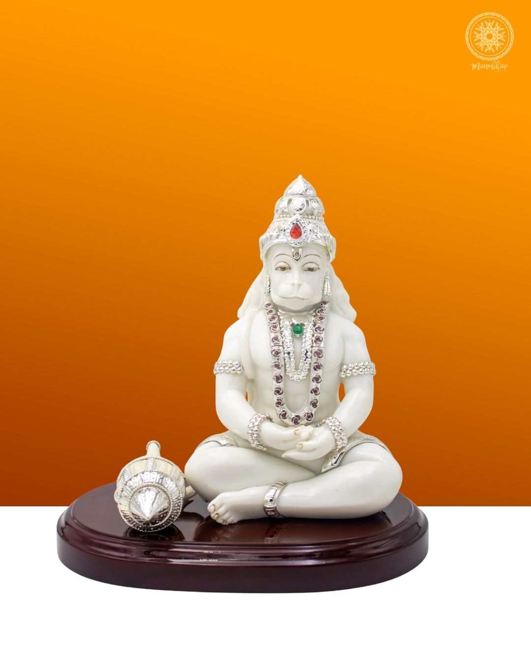 White marble statue of a seated Hanuman Ji with jewelry