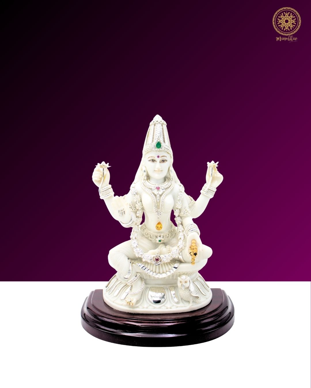 White statue of Laxmi Ji on a wooden base against a purple background